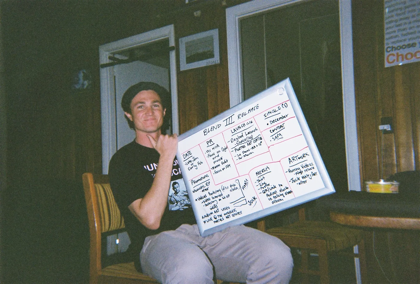 Jack at the Moana house holding up the whiteboard with the Anodised release plan on it