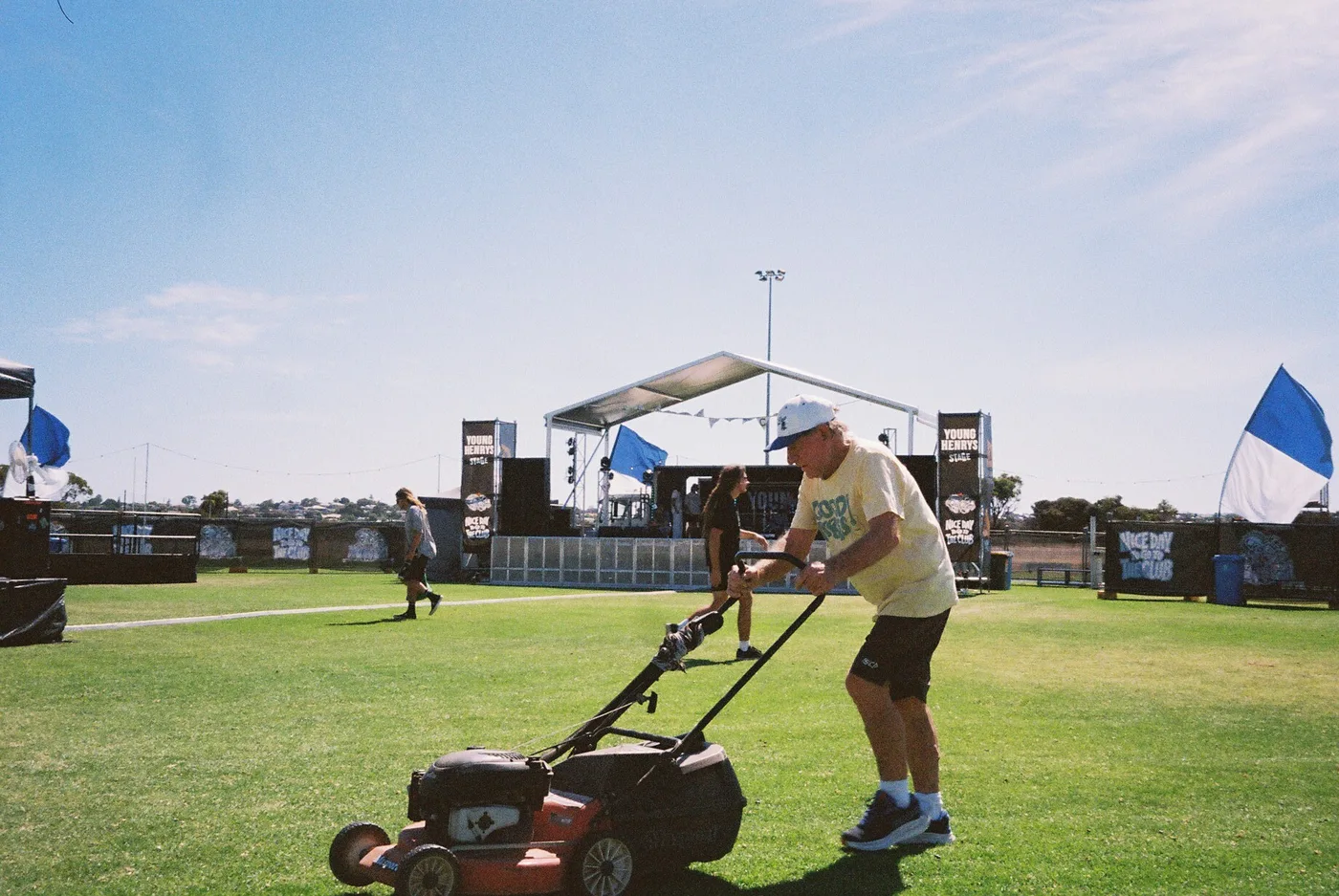 Micky mowing the footy oval in front of the stage before the gates open